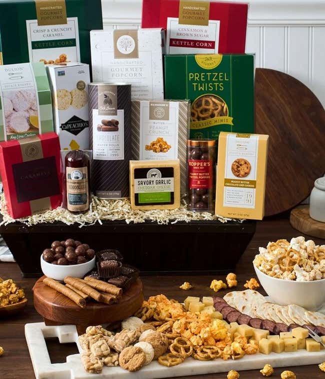 Gourmet snack basket with cheese, popcorn, sausage and more