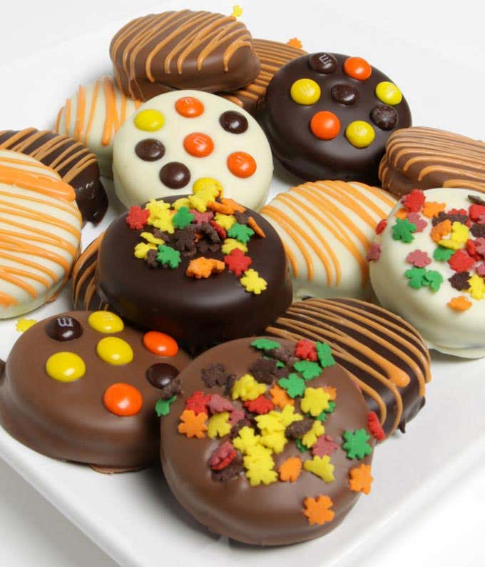A delectable assortment of 12 chocolate-dipped OREO® cookies, coated in white, dark, and milk chocolate, and topped with fall-themed candies.