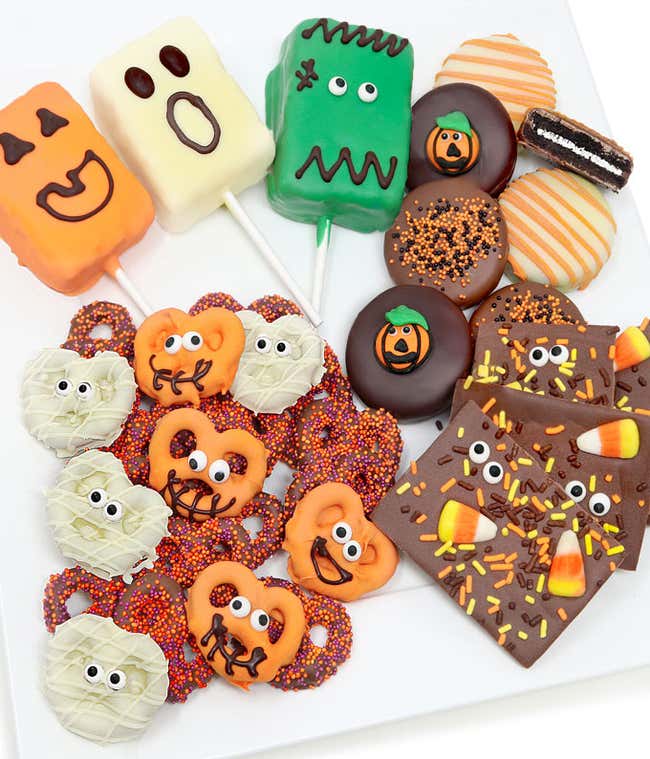 6 chocolate dipped OREO&reg; Cookies with Halloween designs, Chocolate bark with candy corn and yellow, orange, and brown sprinkles, 6 chocolate dipped pretzels (3 orange with eye sprinkles &amp; 3 white with eye sprinkles), and 3 chocolate dipped crispy rice pop