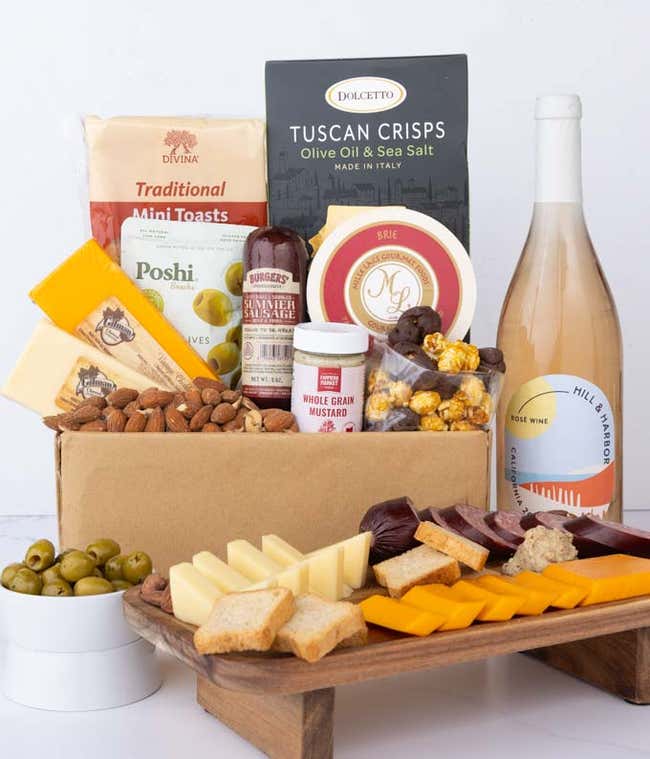An abundent gift box filled with California Ros&eacute; Wine, assorted crackers, two cheeses, summer sausage, and snacks to make an amazing charcuterie spread. 