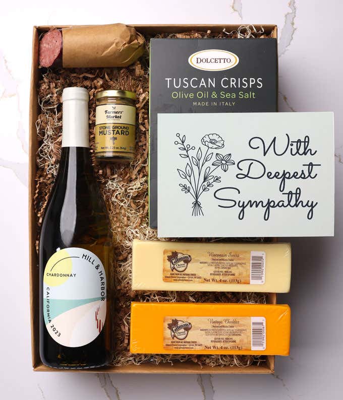 A gift box with a bottle of California Pinot Noir, two types of cheese, 
