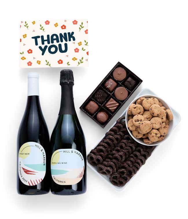 A gift box with chocolate pretzels, chocolate graham crackers, red velvet cookies, hazelnut wafer rolls, an 8 piece box of chocolates, 2 bottles of wine and a Thank You message card.