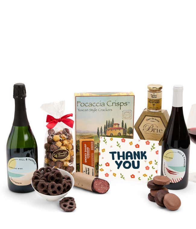 A gift set featuring 2 bottles of Hill &amp; Harbor wine - red and sparkling, focaccia crisps, two cheeses, mustard, summer sausage, caramel popcorn, chocolate pretzels, six chocolate-covered Oreos and a Thank You card to complete the gourmet experience.