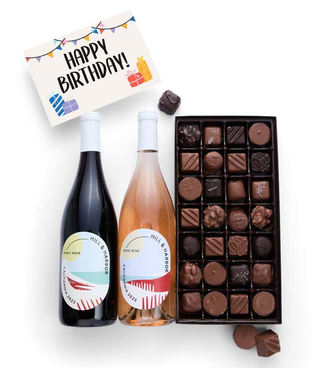 A gift box containing two bottles of California Wine - Pinot Noir &amp; Ros&eacute; wine, a 1 lb box of 28 assorted gourmet chocolates in a grid, and a birthday message card.   A refined combination perfect for birthday celebrations.