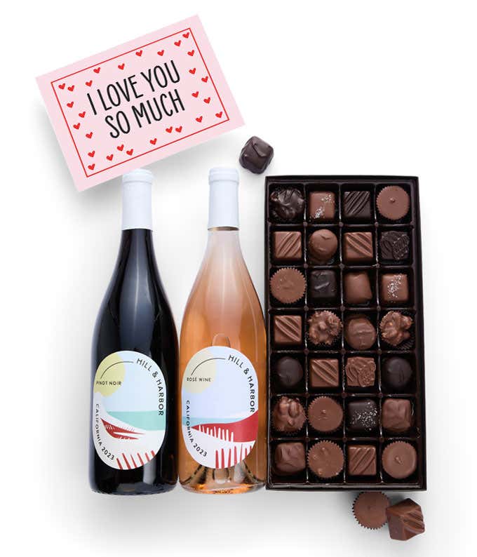 A gift box containing two bottles of California Wine - Pinot Noir & Rosé wine, a 1 lb box of 28 assorted gourmet chocolates in a grid, and an I Love You! message card.   A decadent way to share your love.