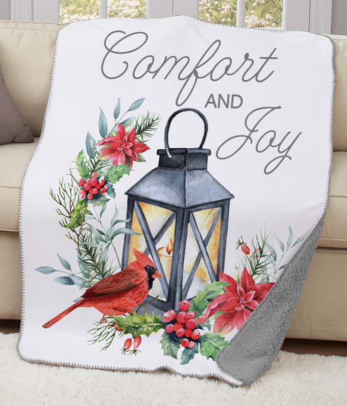  Comfort & Joy Sherpa blanket featuring a red cardinal, lantern, and festive florals in watercolor design.